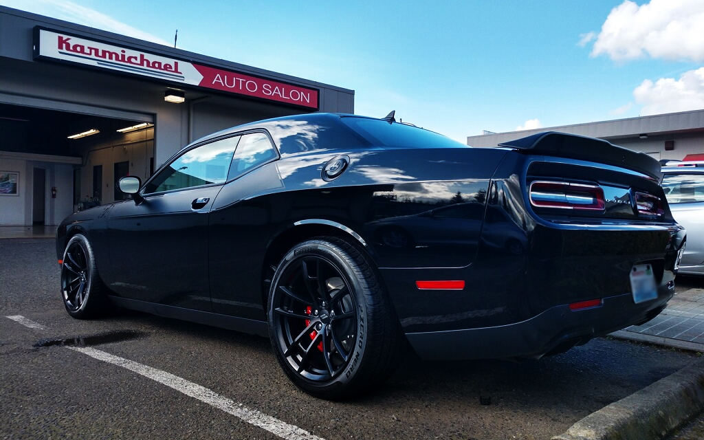 black shiny car black rims in lot