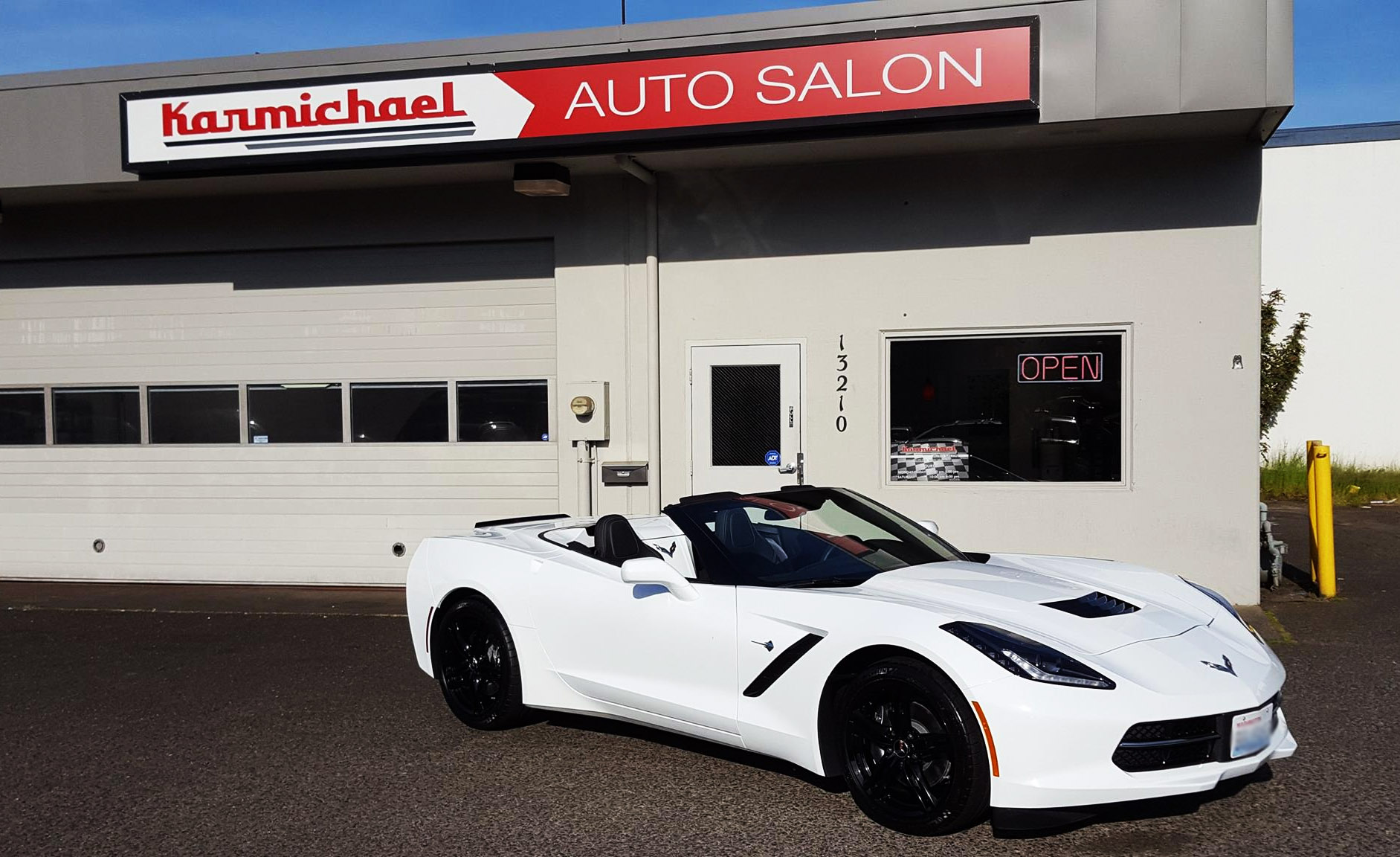 white sports car convertible in lot