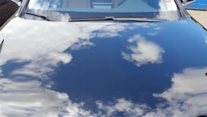 reflection sky clouds in car hood