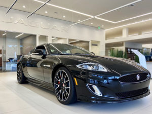 black shiny sports car in showroom jaguar